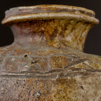 Close-up of an antique Shigaraki jar's short neck and rolled rim, with mottled cream and brown natural ash glaze and hand-incised cypress-fence lines across the shoulder.